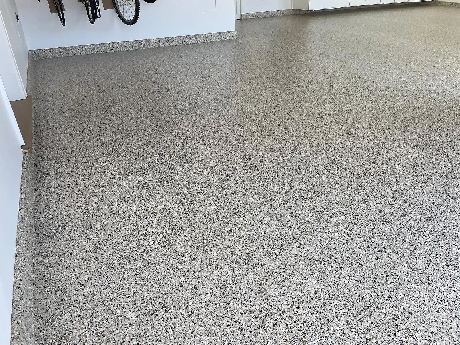 Completed epoxy floor coating running through a commercial storage room