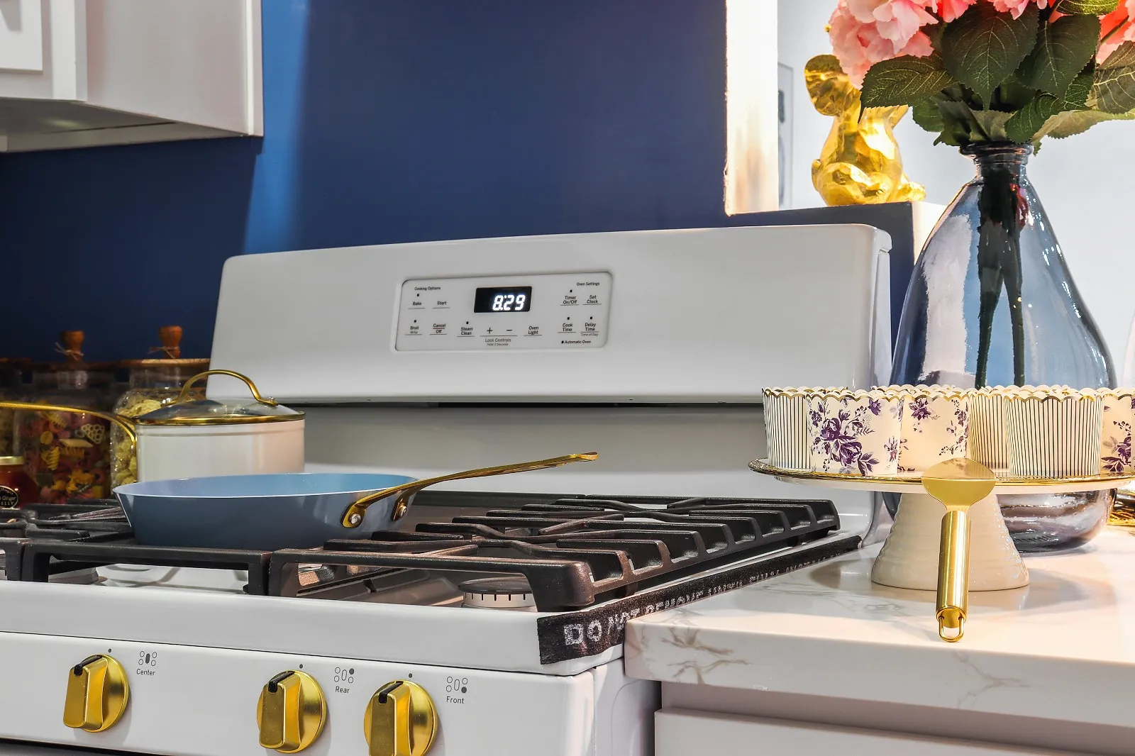 Finished kitchen with a gas range, brass fittings and a blue tiled splashback