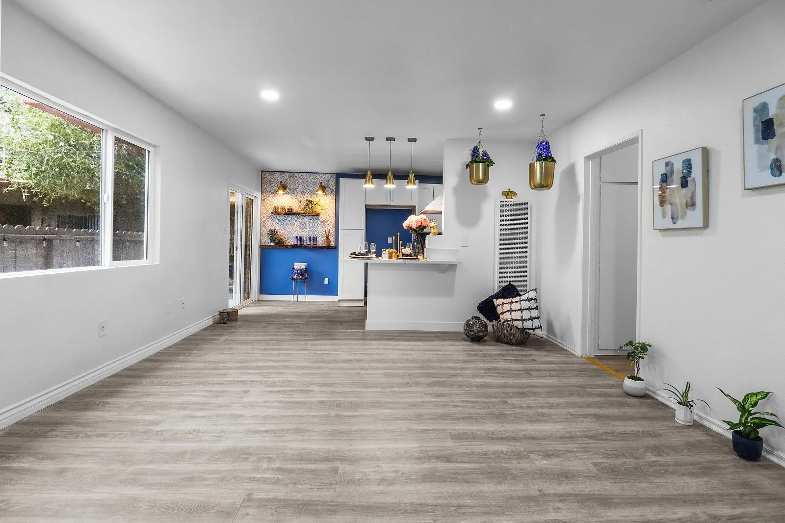 Completed open-plan interior with wood-look flooring and natural light from side windows