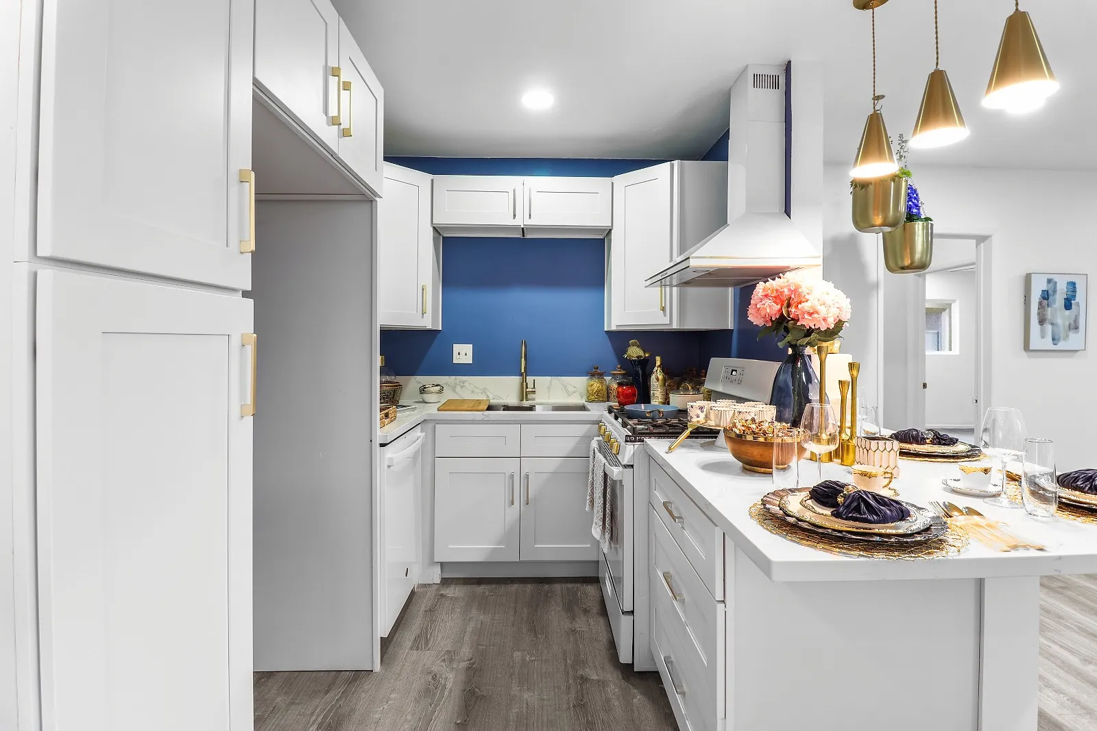 Finished kitchen with an island, pendant lights and full-height cabinetry